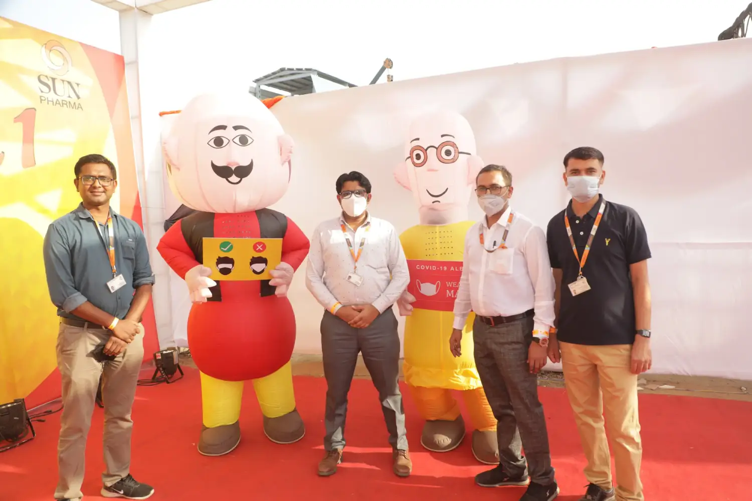 Man and woman speaking on stage at night with blue lighting